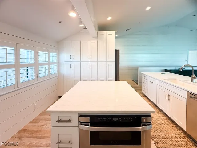 a kitchen with a stove and white cabinets