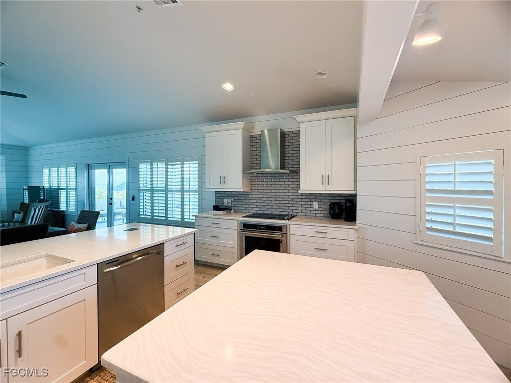 4560 Conch Shell Drive Upper Captiva, FL 33924 - Photo 32 of 50 a large kitchen with kitchen island a sink stainless steel appliances and cabinets
