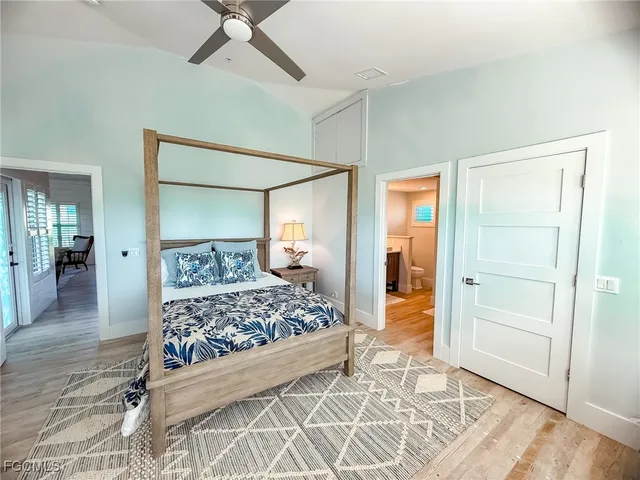 a bedroom with a bed and a mirror
