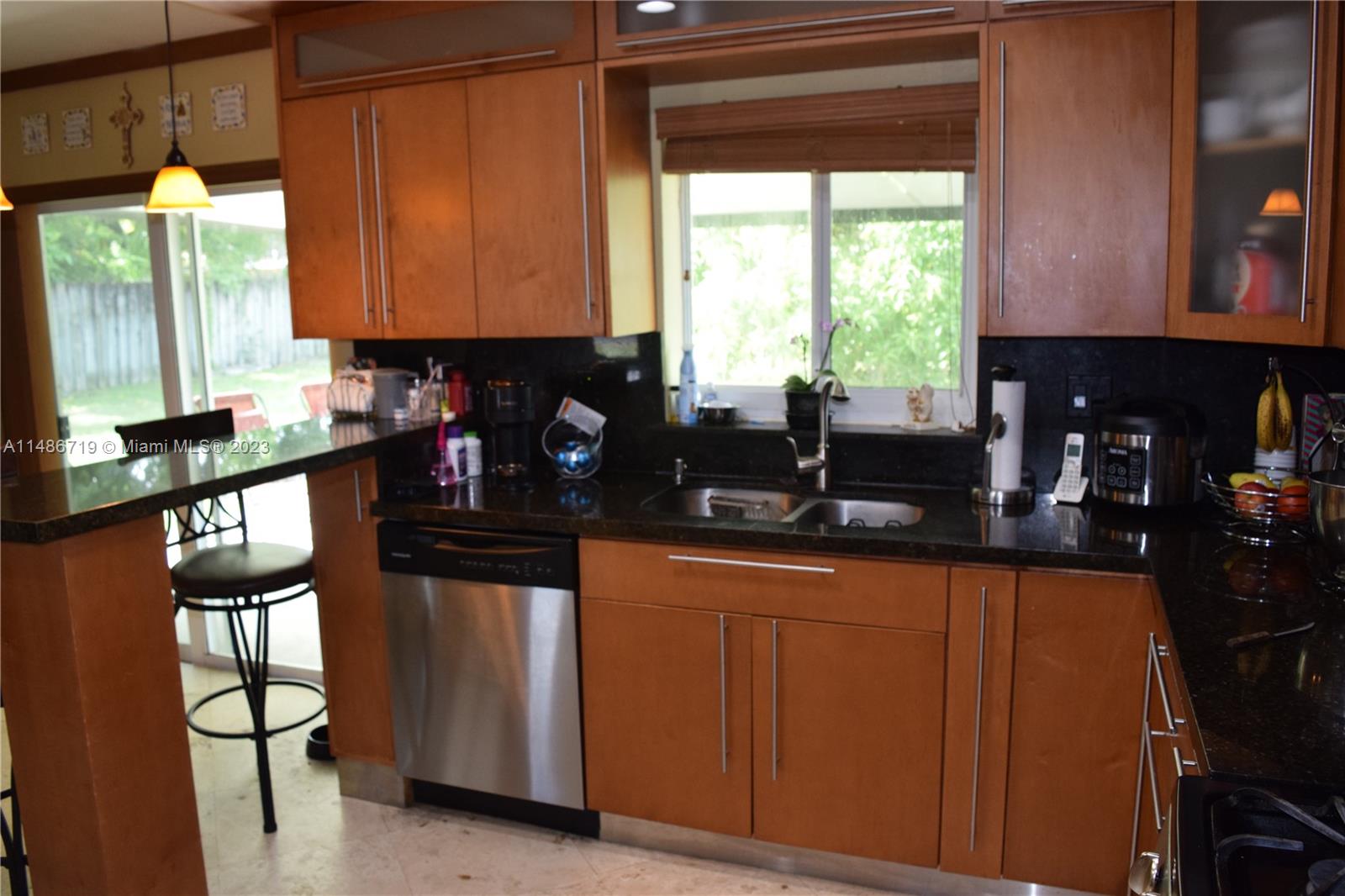 Palmetto Estates Miami, FL 33157 - Photo 9 of 20 a kitchen with granite countertop a sink and a window