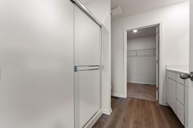 a view of hallway with wooden floor