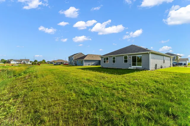 a view of a house with yard and sitting area