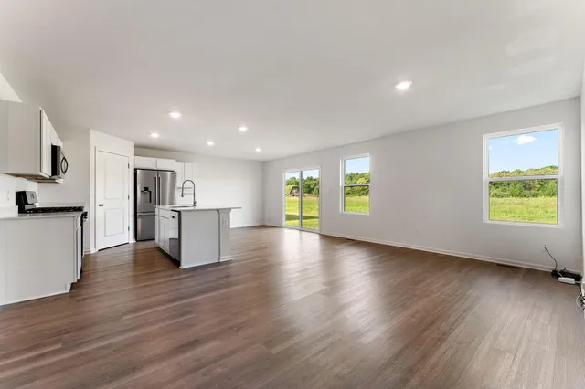 a view of kitchen with furniture and wooden floor