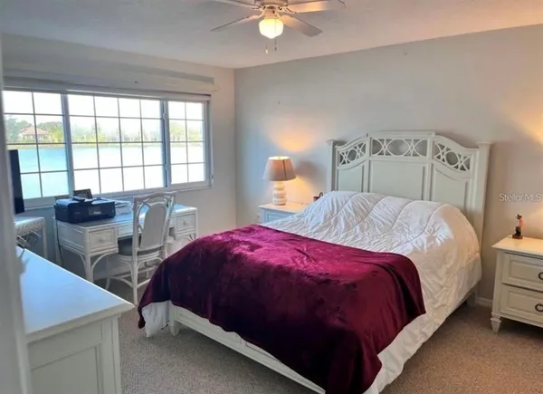 a bedroom with a bed and a table
