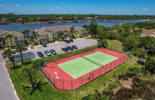 an aerial view of a house with outdoor space and lake view