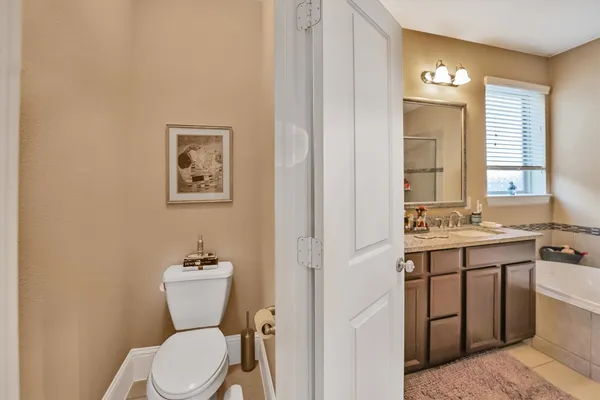 a bathroom with a double vanity sink a mirror and a bathtub