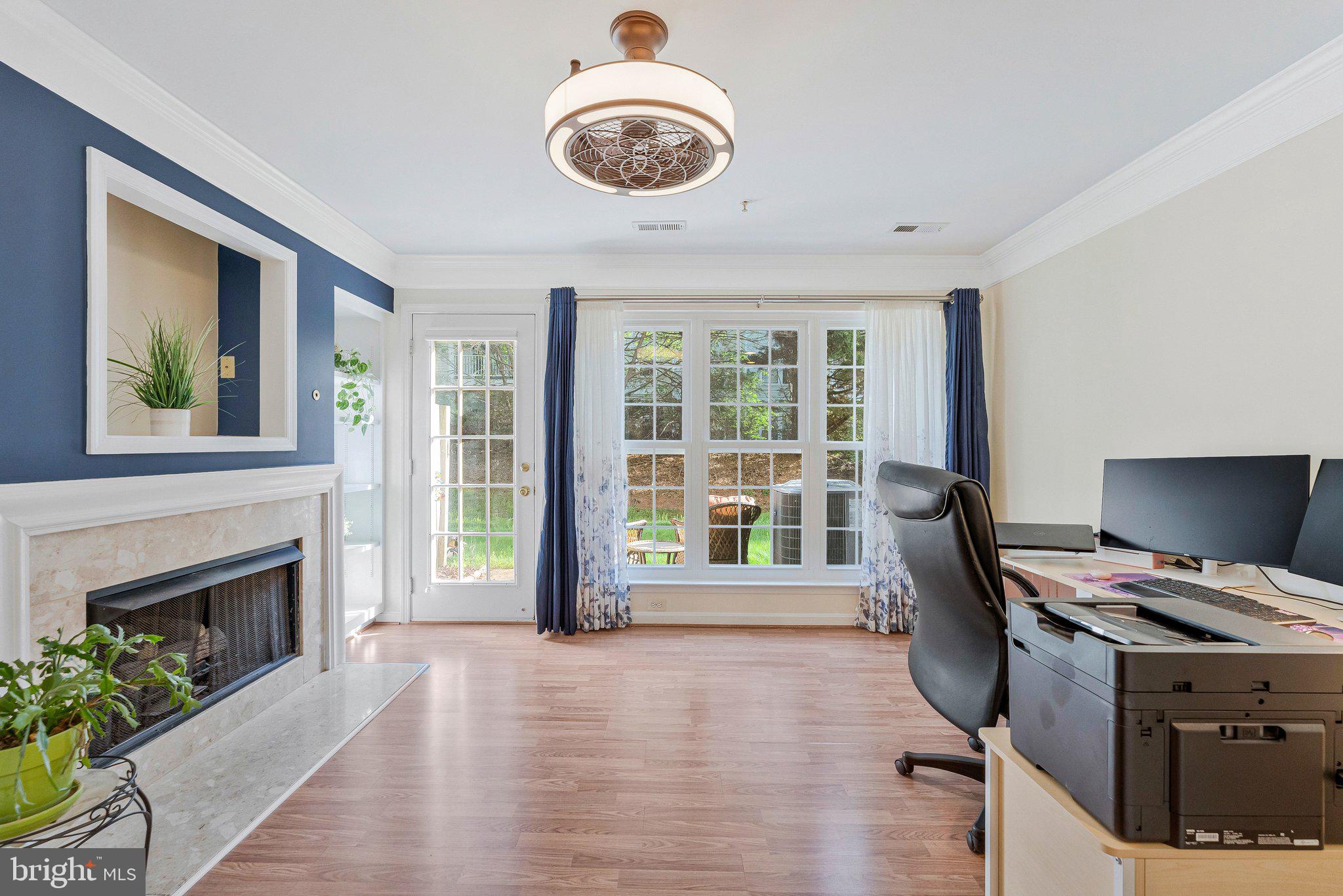 21789 Baldwin Square, Unit 21789 Sterling, VA 20164 - Photo 12 of 33 a view of a livingroom with furniture wooden floor and a fireplace