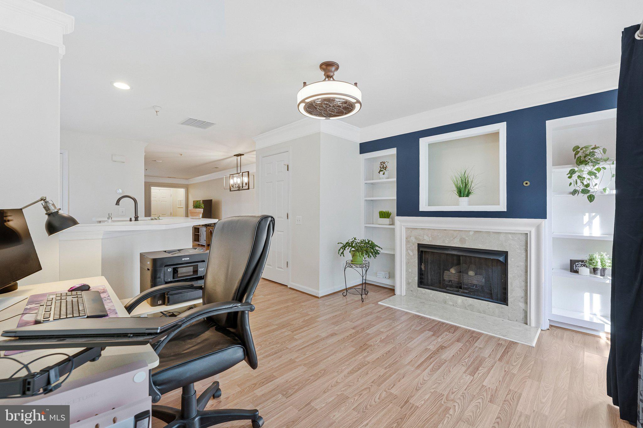 21789 Baldwin Square, Unit 21789 Sterling, VA 20164 - Photo 13 of 33 a view of a workspace with furniture and a fireplace