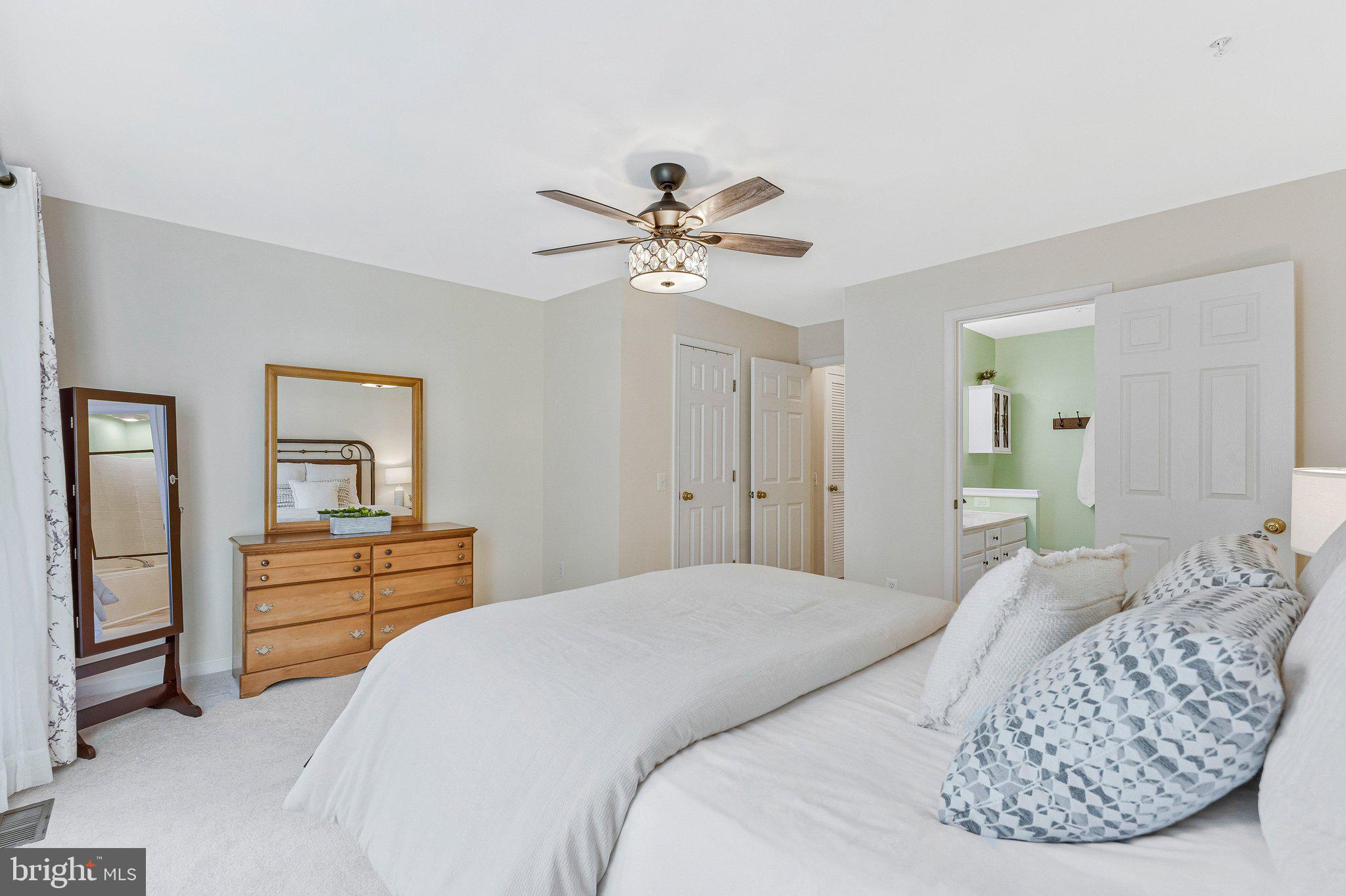 21789 Baldwin Square, Unit 21789 Sterling, VA 20164 - Photo 16 of 33 a bedroom with a bed and ceiling fan
