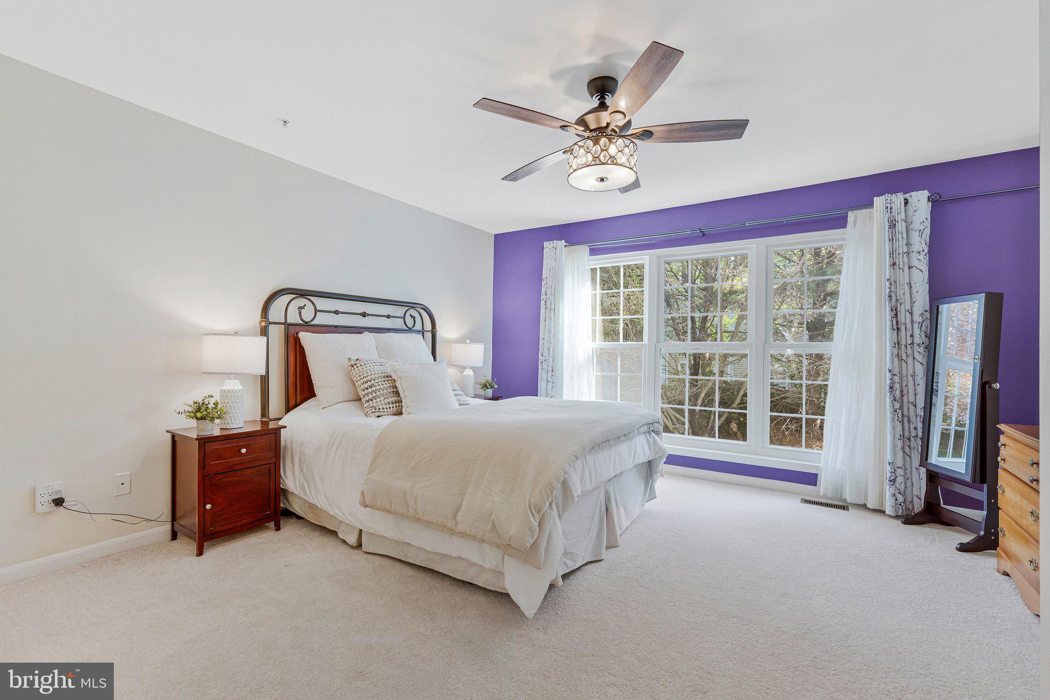 21789 Baldwin Square, Unit 21789 Sterling, VA 20164 - Photo 17 of 33 a bedroom with a bed and a chandelier
