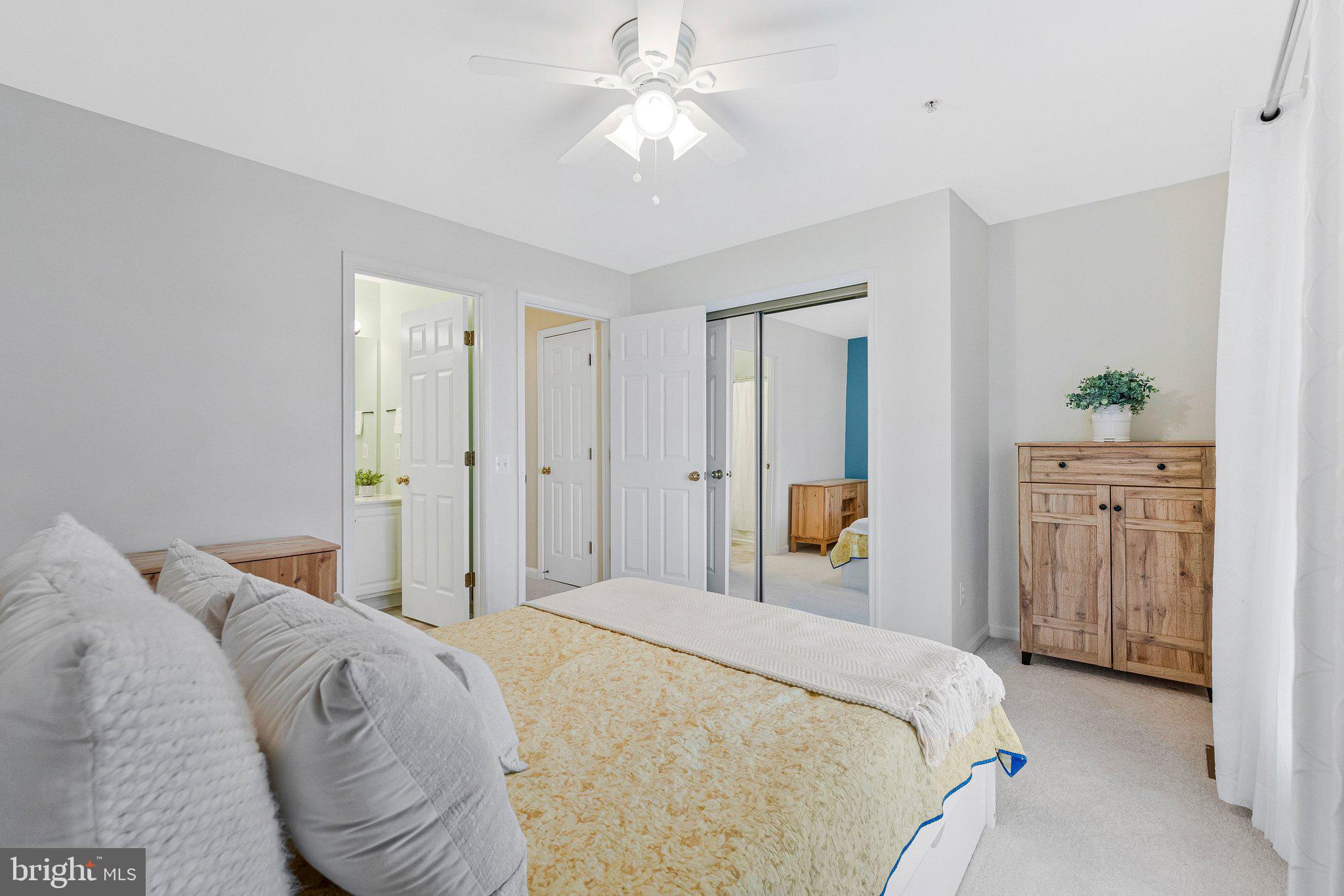 21789 Baldwin Square, Unit 21789 Sterling, VA 20164 - Photo 22 of 33 a bedroom with a large bed and a chandelier