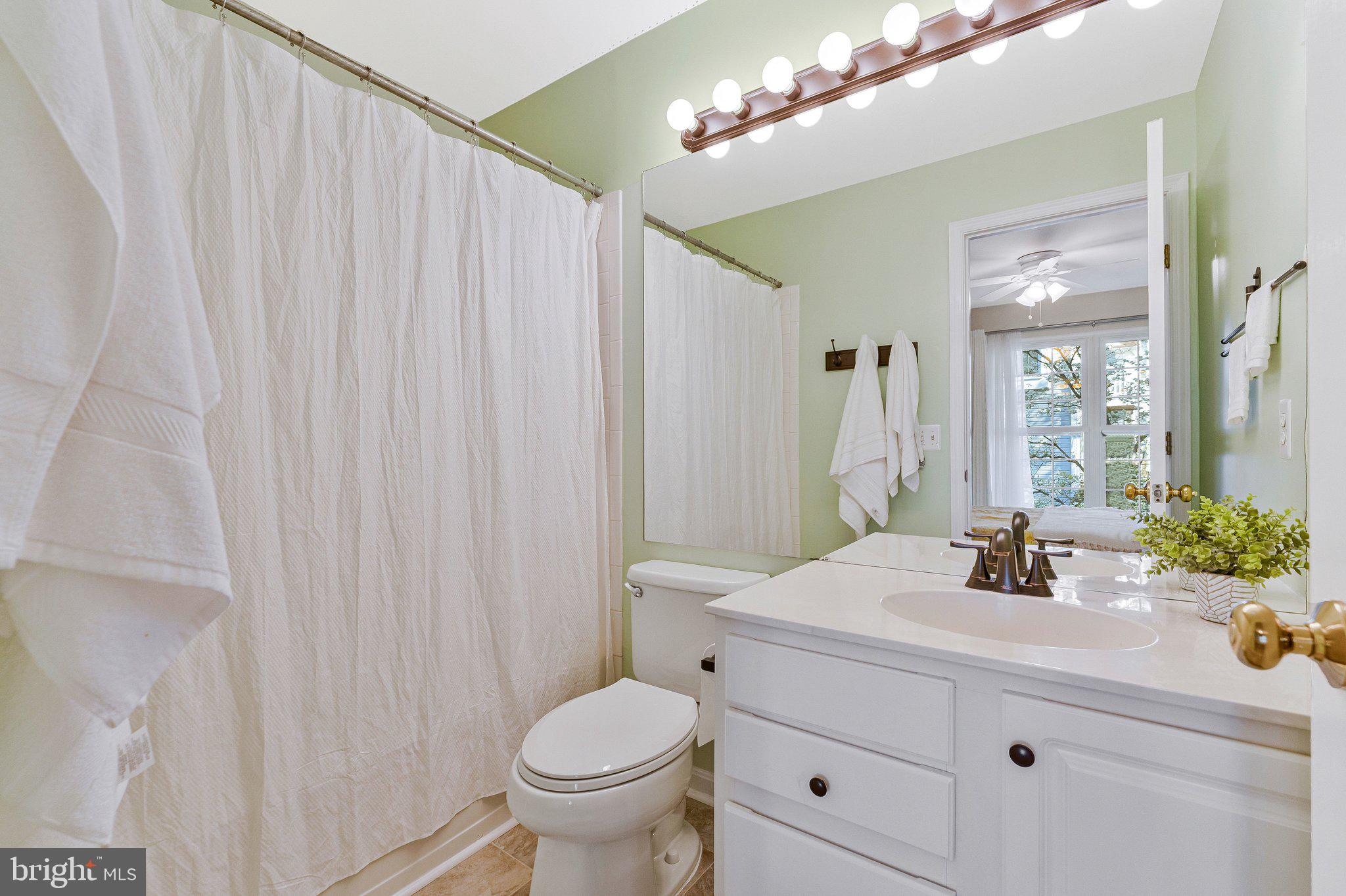 21789 Baldwin Square, Unit 21789 Sterling, VA 20164 - Photo 23 of 33 a bathroom with a sink a toilet and mirror