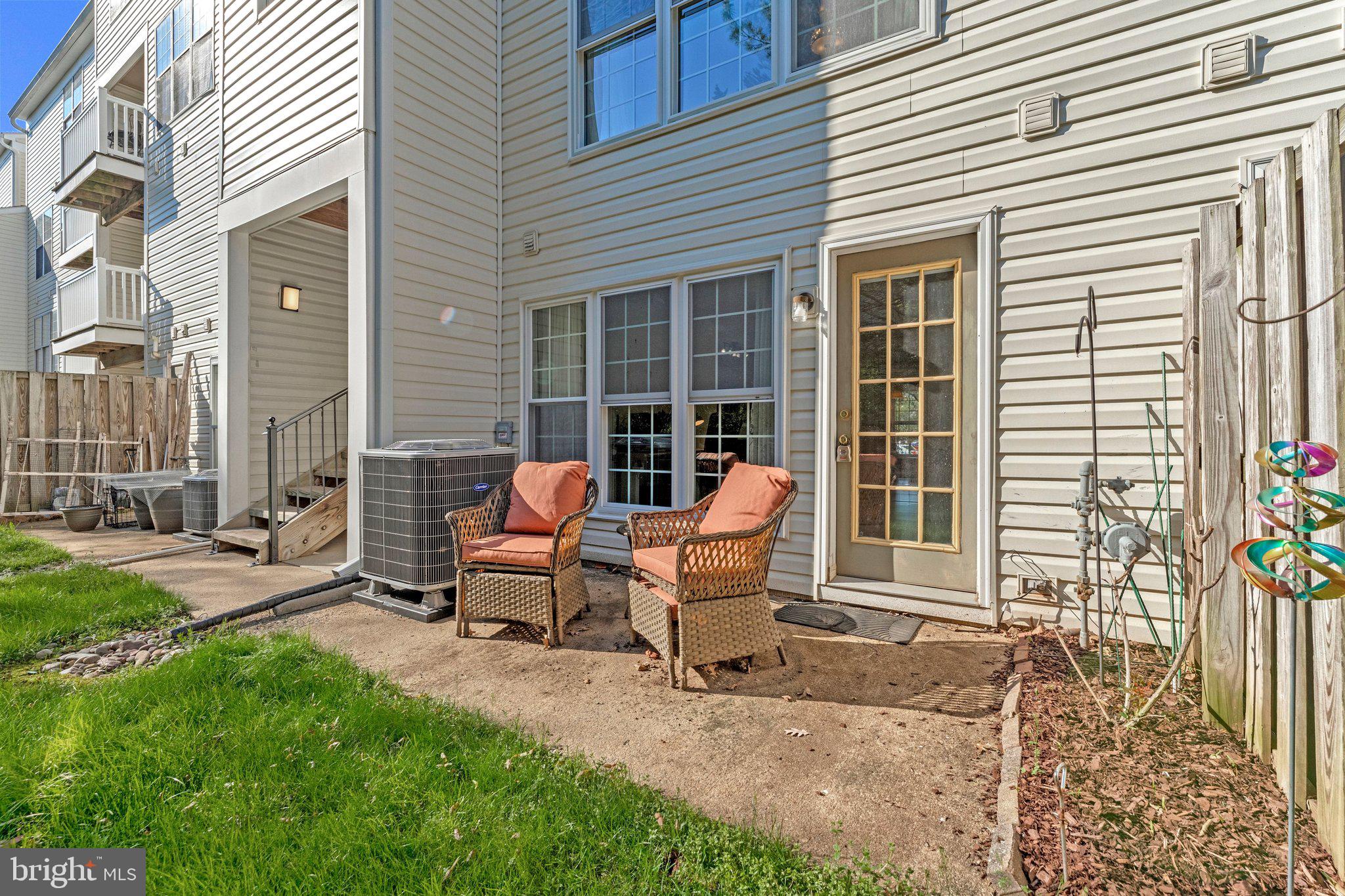 21789 Baldwin Square, Unit 21789 Sterling, VA 20164 - Photo 24 of 33 a view of a house with backyard and sitting area