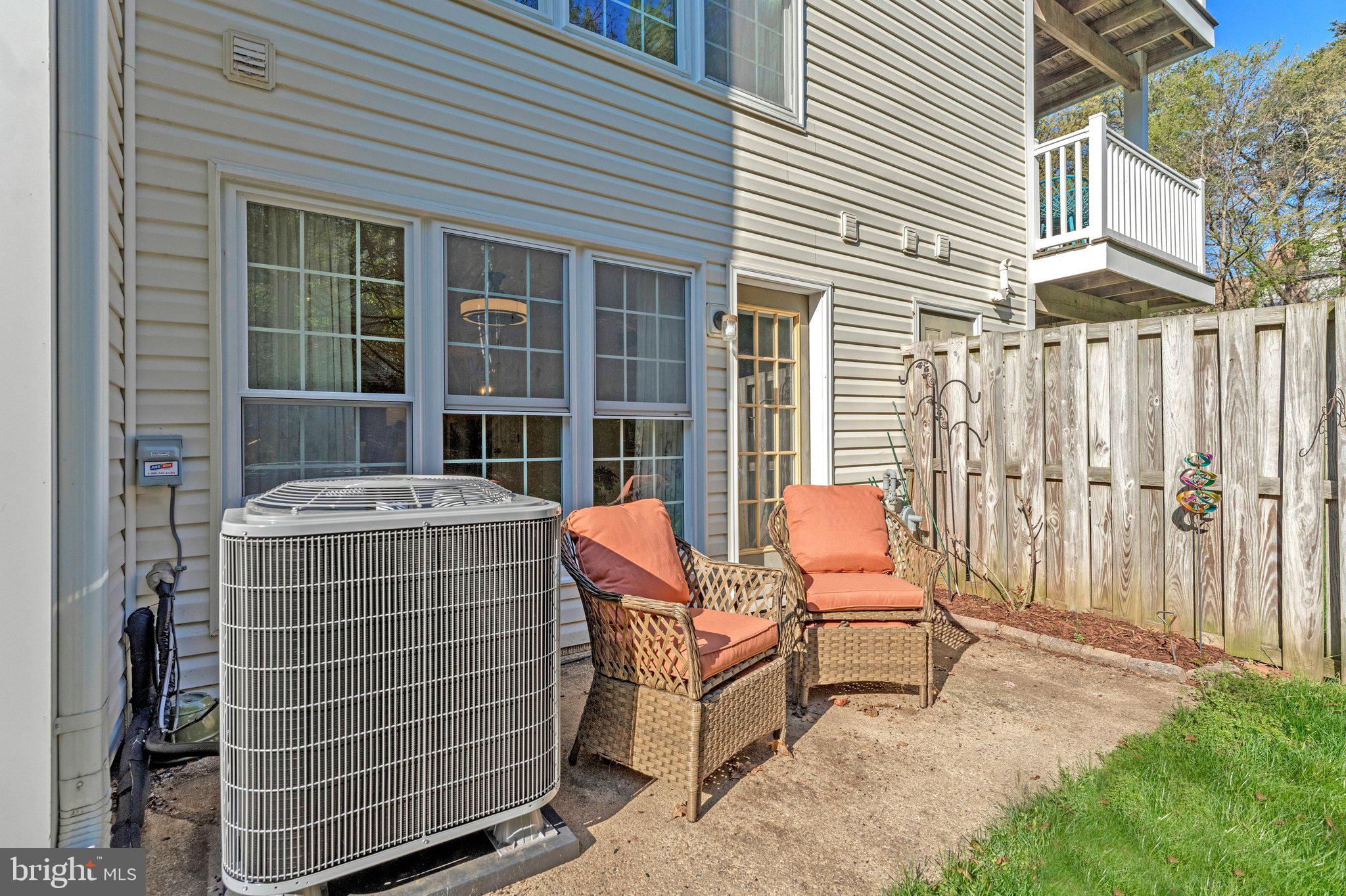 21789 Baldwin Square, Unit 21789 Sterling, VA 20164 - Photo 25 of 33 a view of a patio with a table and chairs