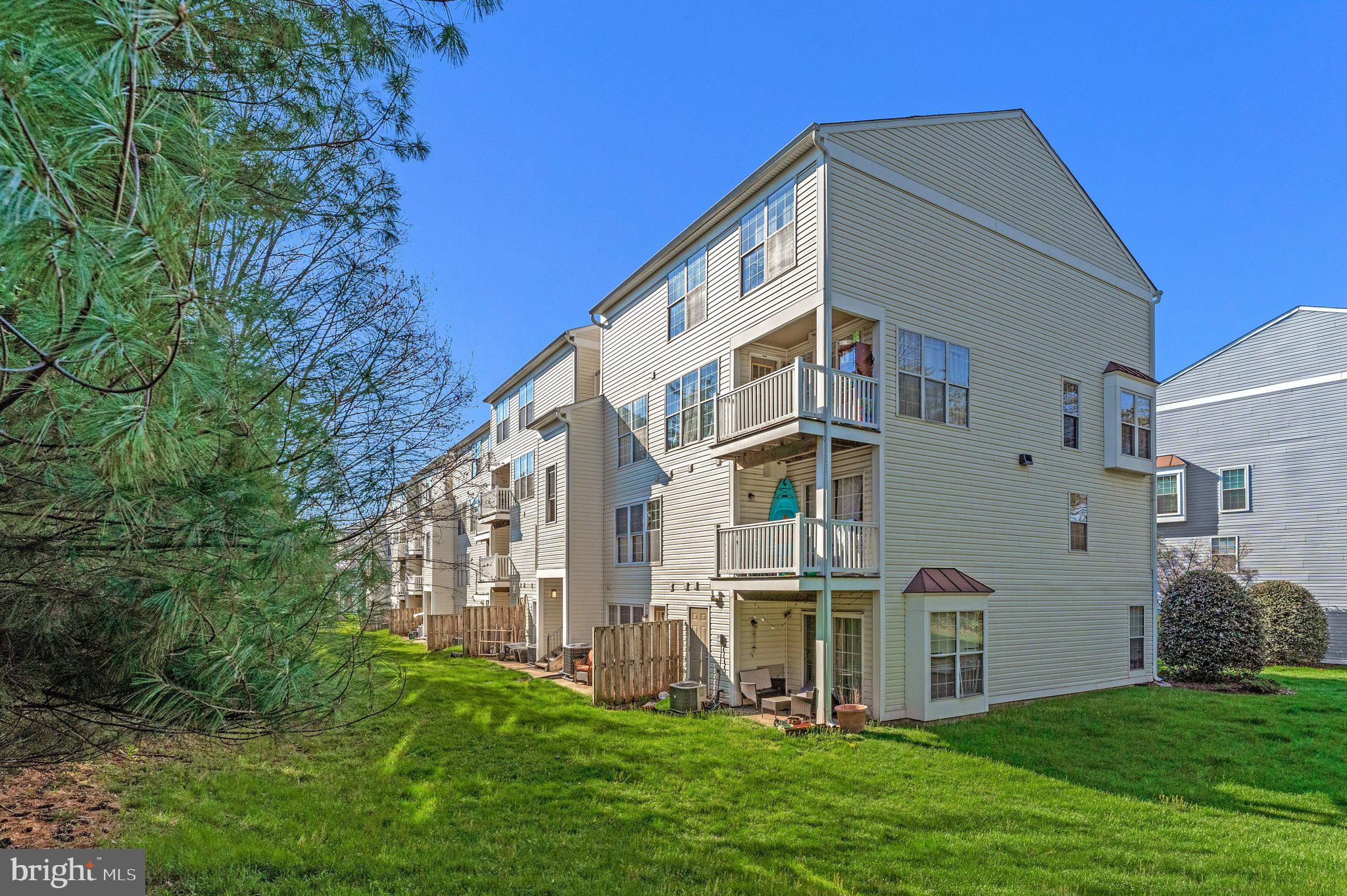 21789 Baldwin Square, Unit 21789 Sterling, VA 20164 - Photo 30 of 33 a front view of a house with a yard