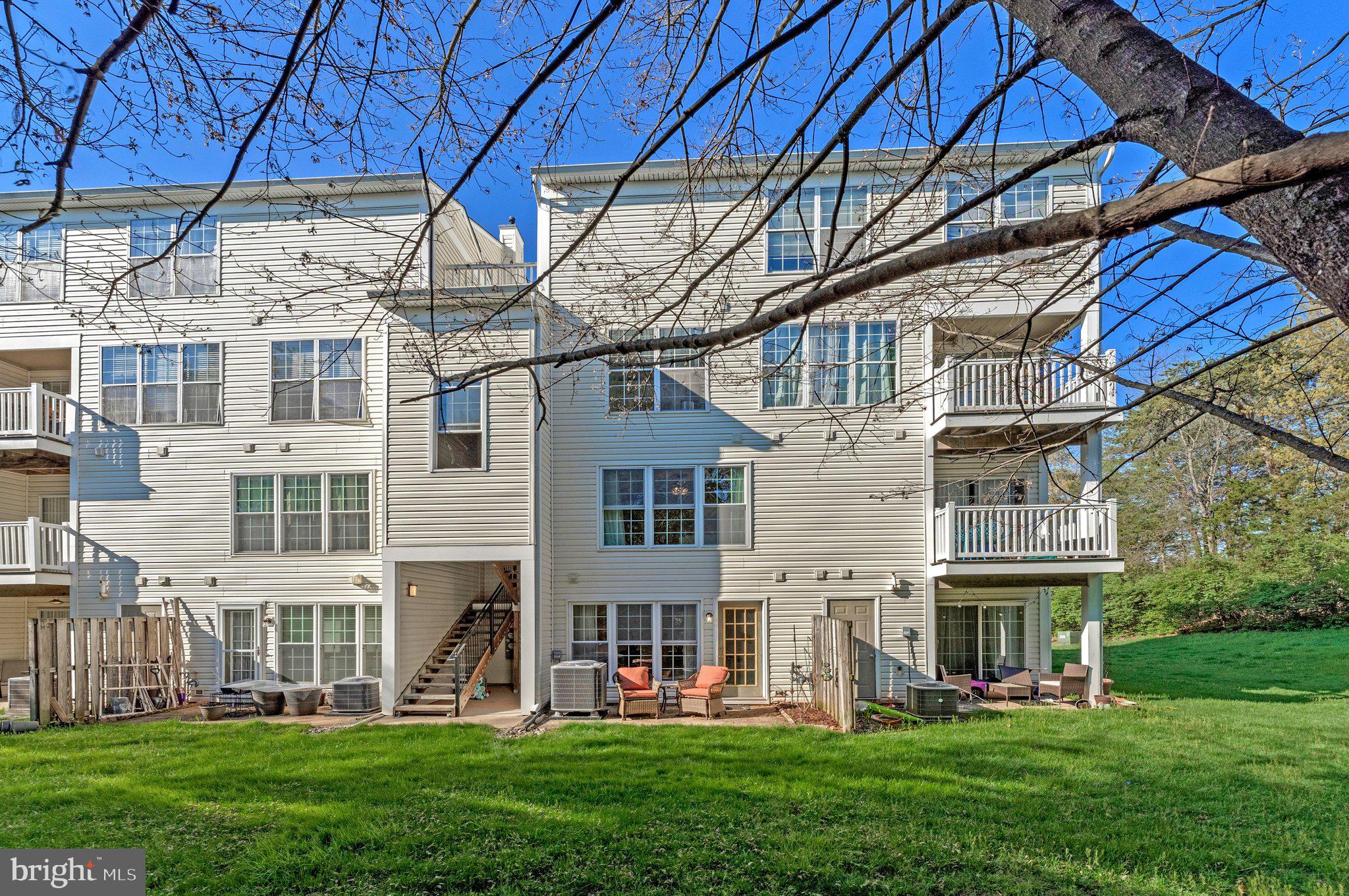 21789 Baldwin Square, Unit 21789 Sterling, VA 20164 - Photo 31 of 33 front view of a house with a yard