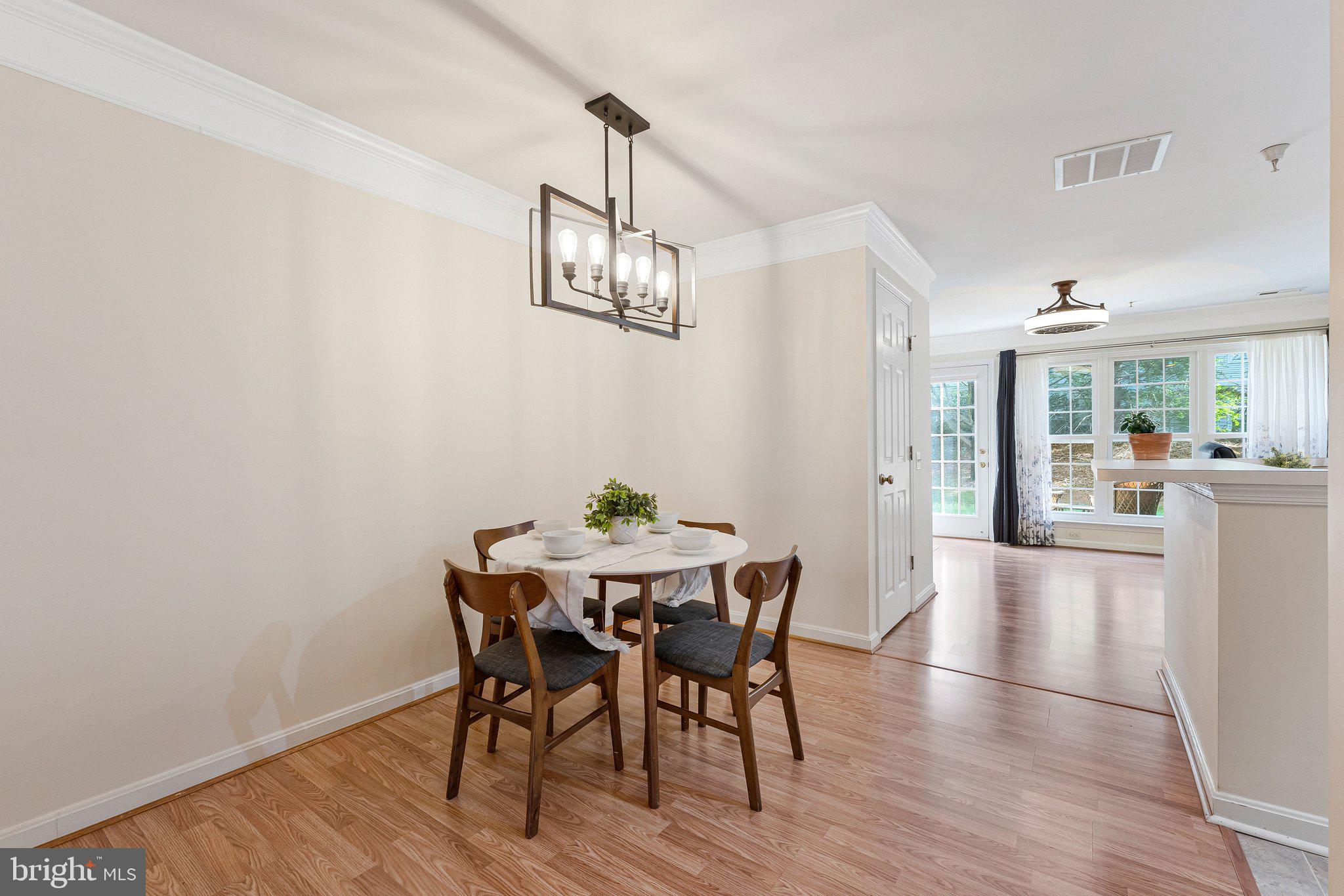 21789 Baldwin Square, Unit 21789 Sterling, VA 20164 - Photo 6 of 33 a view of a dining room with furniture and chandelier