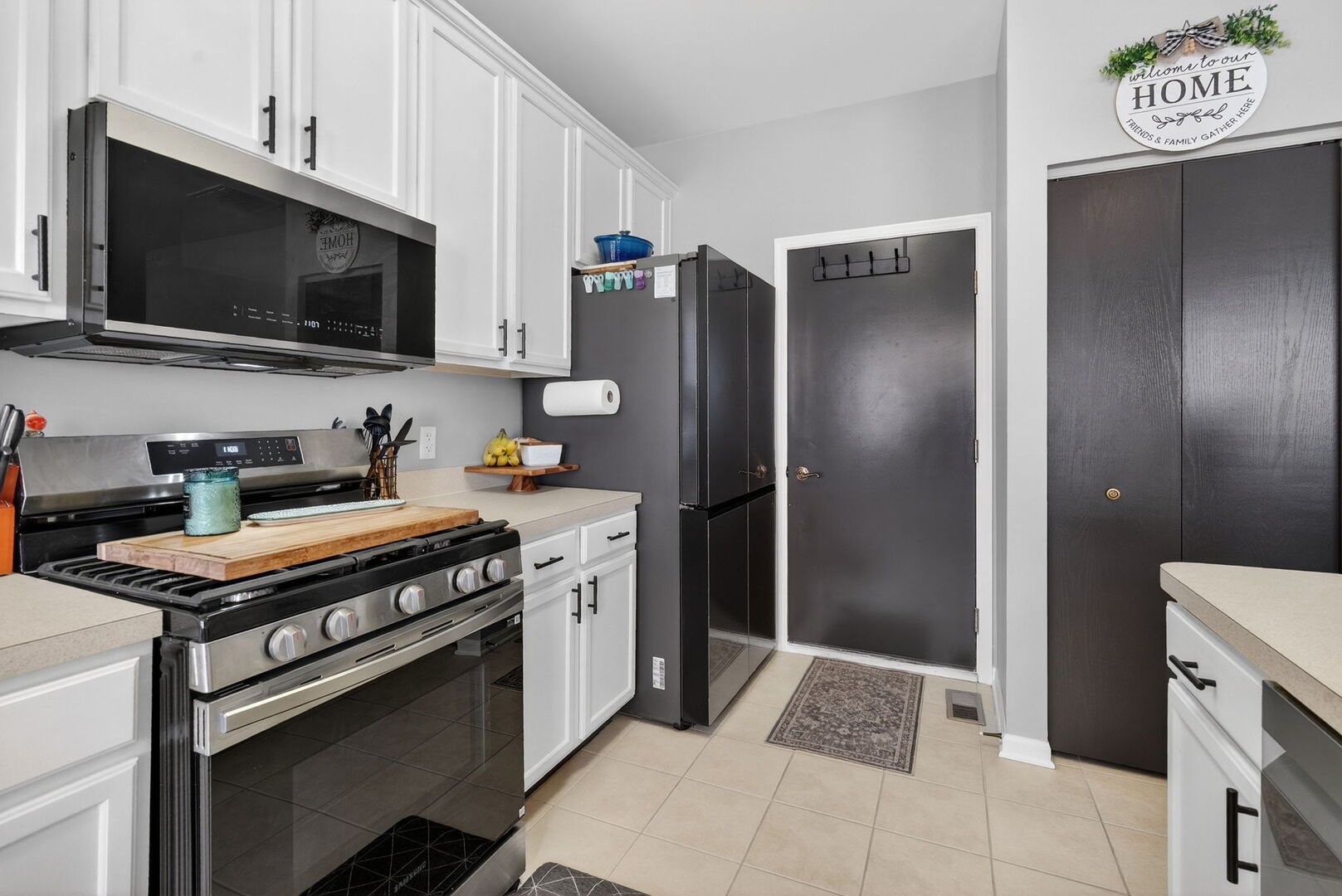 1596 Ludington Circle Romeoville, IL 60446 - Photo 15 of 37 a kitchen with stainless steel appliances a stove a microwave and a refrigerator