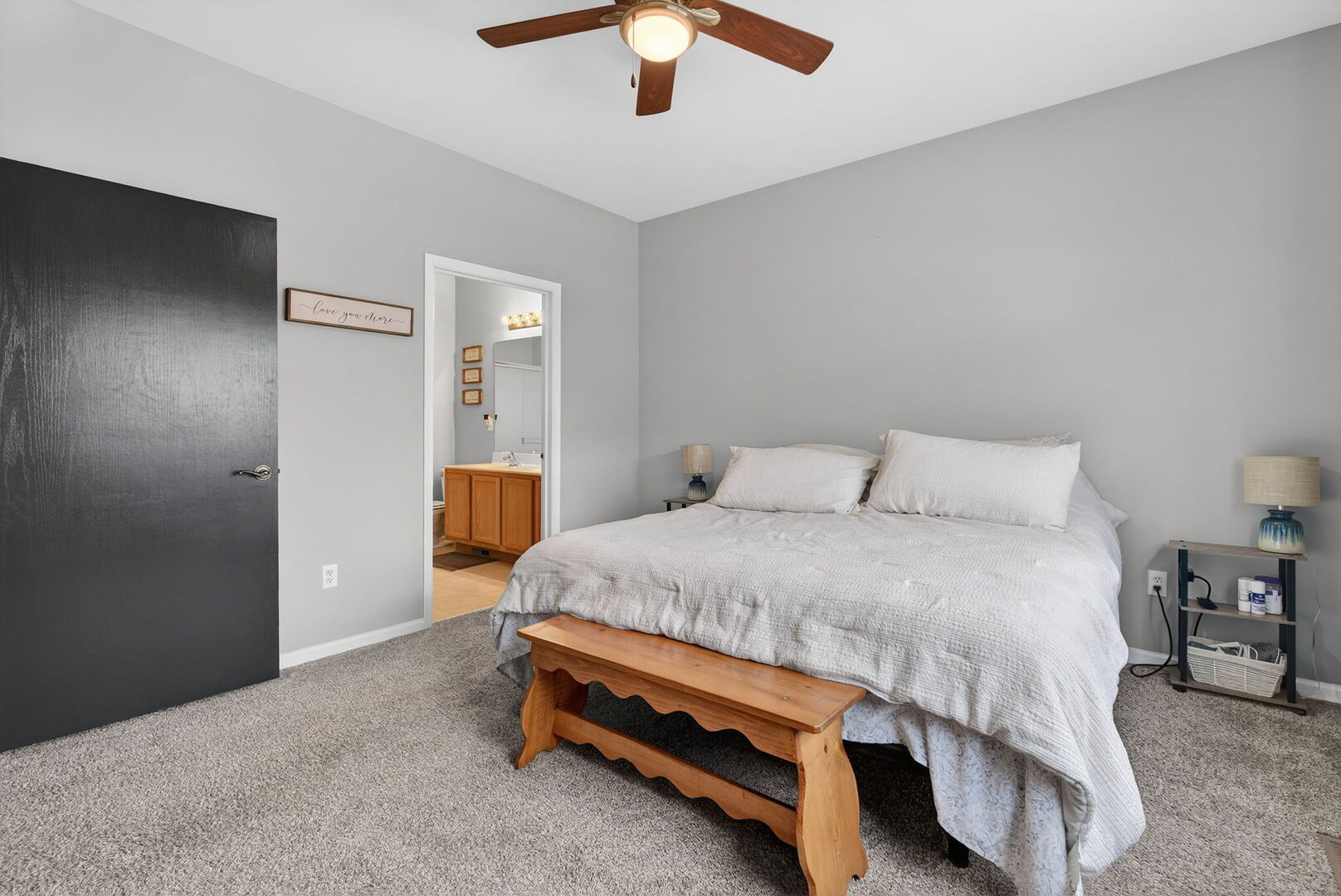 1596 Ludington Circle Romeoville, IL 60446 - Photo 21 of 37 a bedroom with a bed and a chandelier