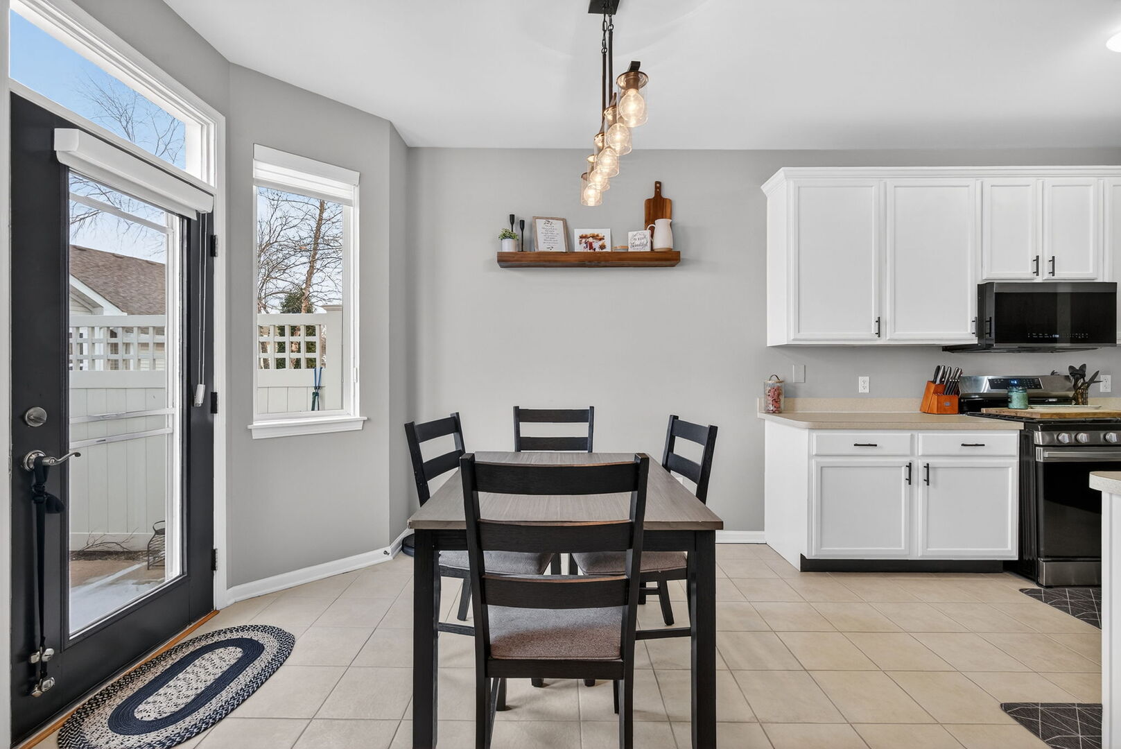 1596 Ludington Circle Romeoville, IL 60446 - Photo 10 of 37 a kitchen with a dining table chairs and white appliances