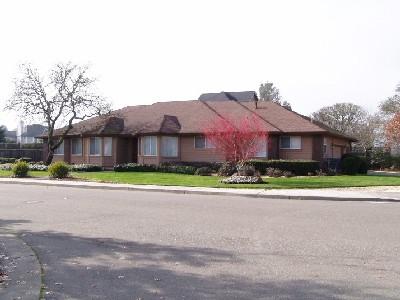 front view of house and a yard and car parked