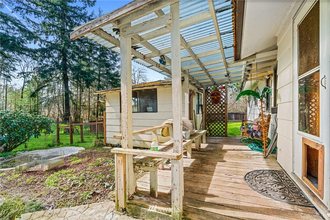187 Limmer Road Winlock, WA 98596 - Photo 12 of 17 a view of a patio with table and chairs with wooden floor and fence
