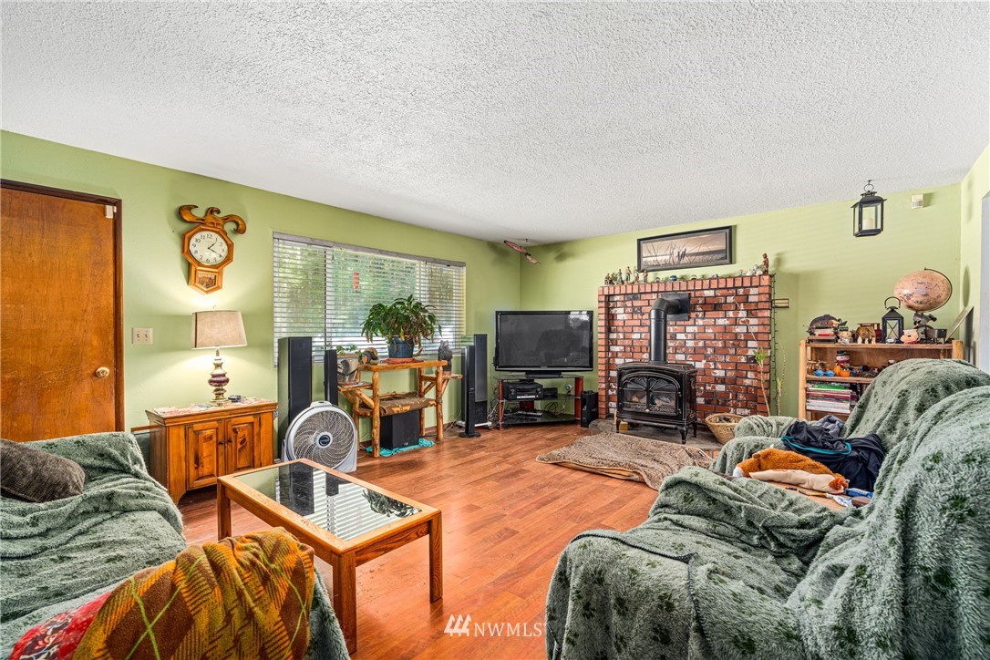 187 Limmer Road Winlock, WA 98596 - Photo 4 of 17 a room with furniture a flat screen tv and a large window