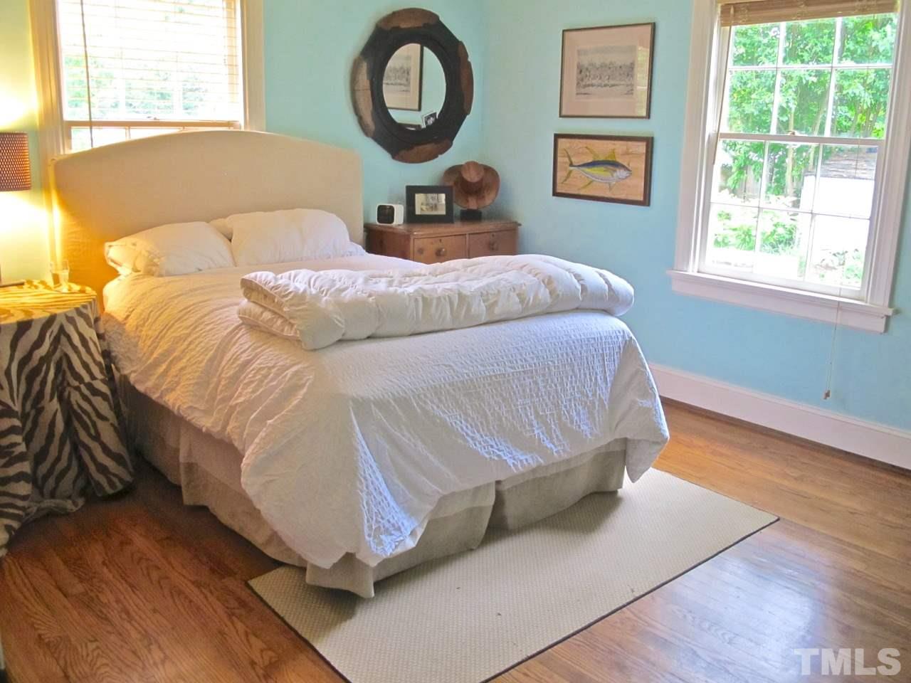 1607 Carson Street Raleigh, NC 27608 - Photo 11 of 16 a bedroom with a bed and a window
