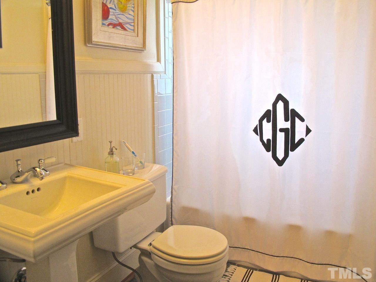 1607 Carson Street Raleigh, NC 27608 - Photo 12 of 16 a bathroom with a sink toilet and mirror