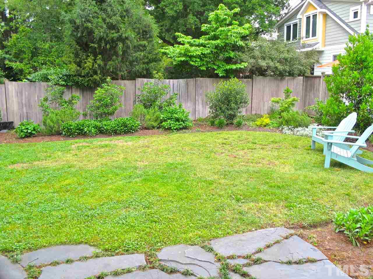 1607 Carson Street Raleigh, NC 27608 - Photo 14 of 16 a backyard of a house with plants and large trees