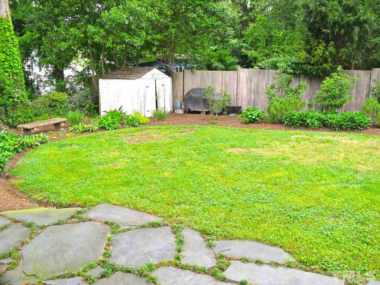 1607 Carson Street Raleigh, NC 27608 - Photo 15 of 16 a view of a backyard with plants and large trees