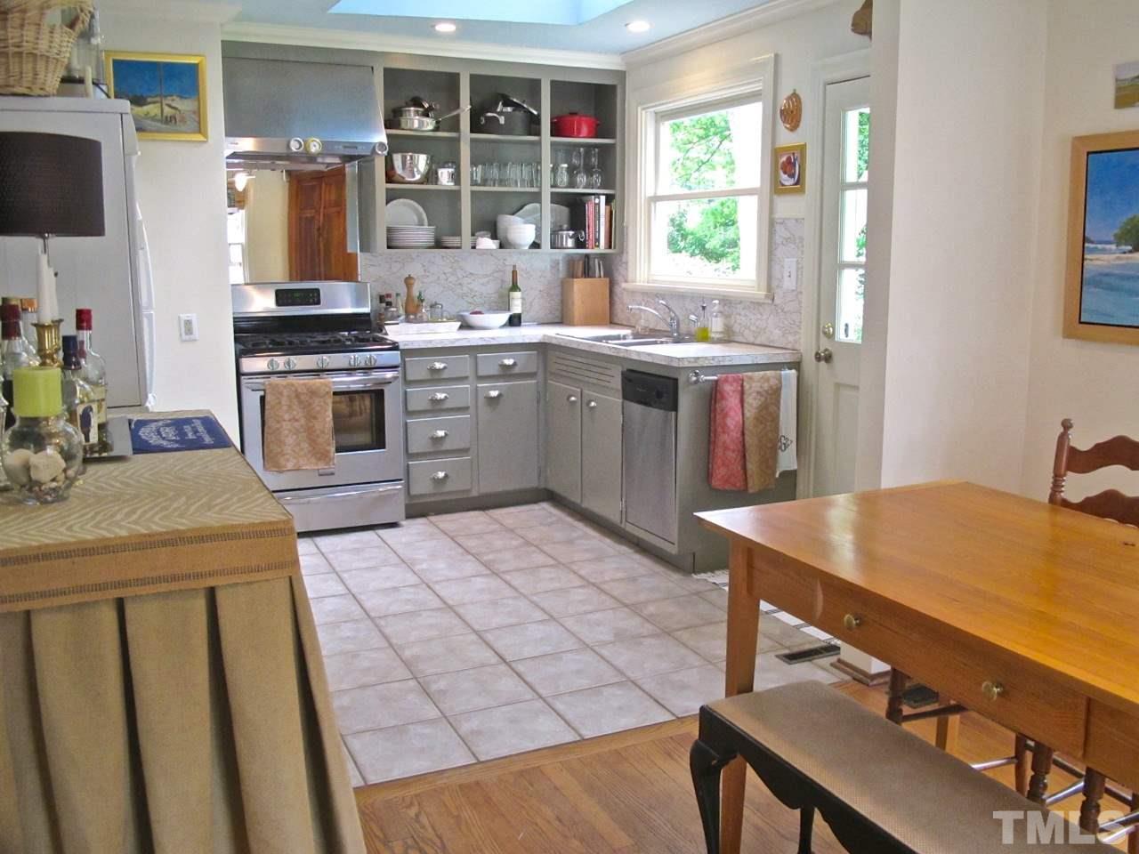 1607 Carson Street Raleigh, NC 27608 - Photo 9 of 16 a kitchen that has a sink a stove top oven a counter space and cabinets