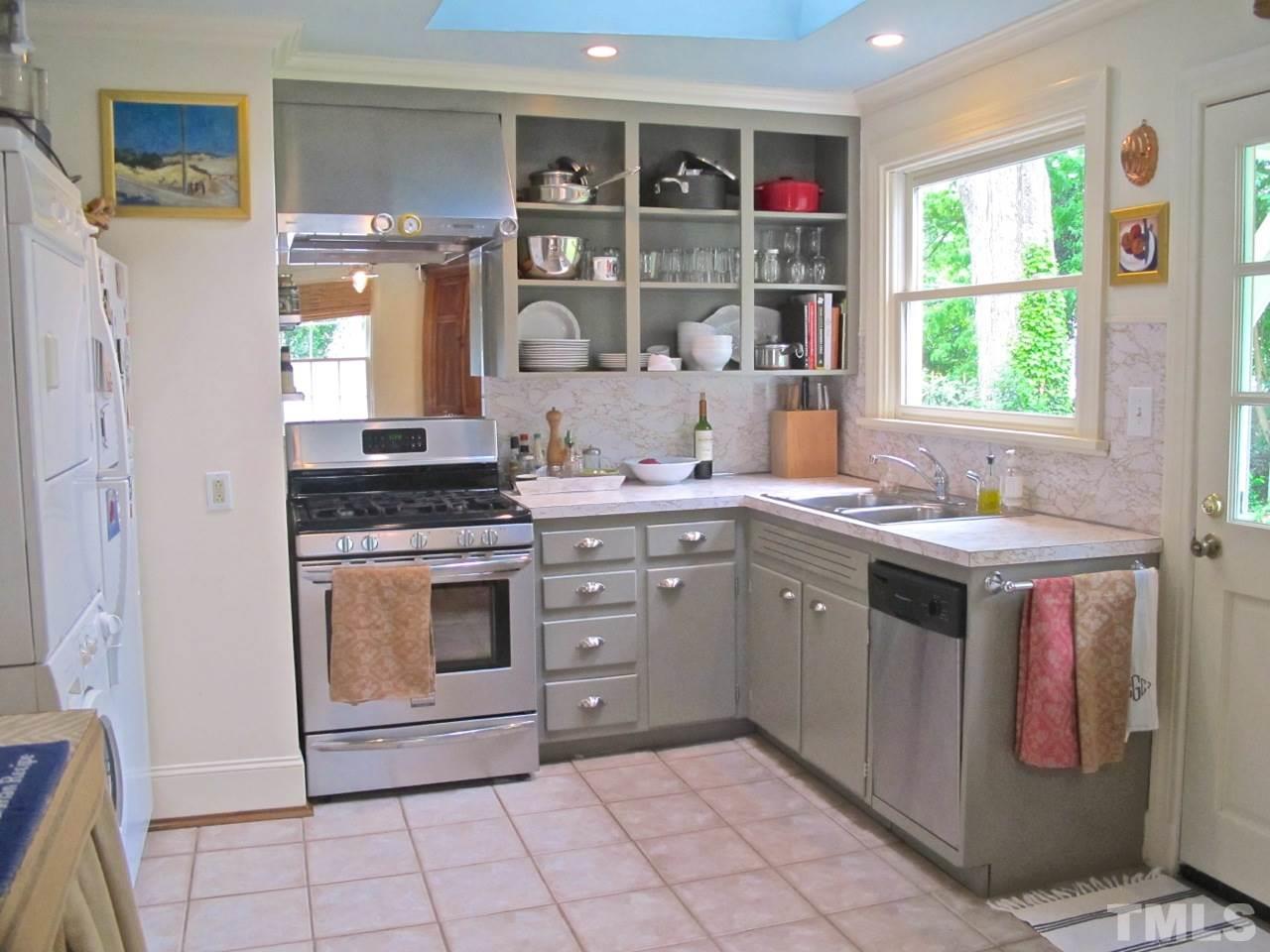 1607 Carson Street Raleigh, NC 27608 - Photo 10 of 16 a kitchen with a stove sink and cabinets