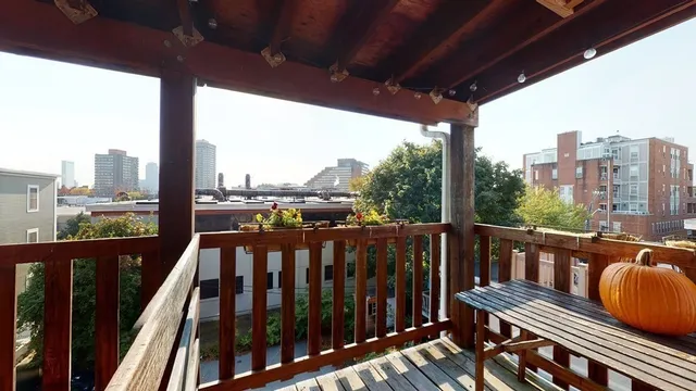 a view of a balcony with wooden floor