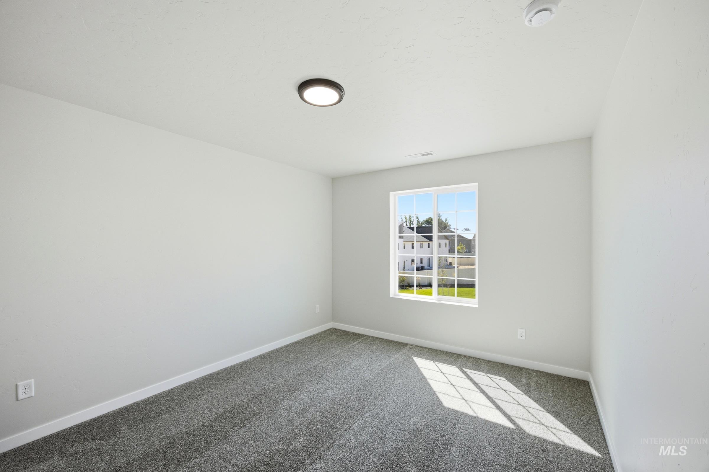 13333 Bank Street Caldwell, ID 83607 - Photo 28 of 29 White walls, gray carpeting, and a single window with white trim