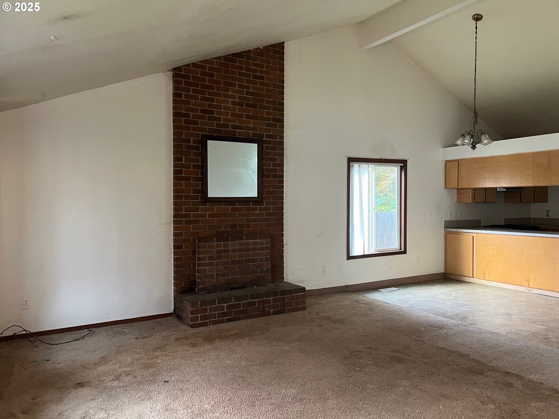 18830 Southwest Butternut Street Beaverton, OR 97078 - Photo 2 of 13 a view of an empty room with a fireplace and a window