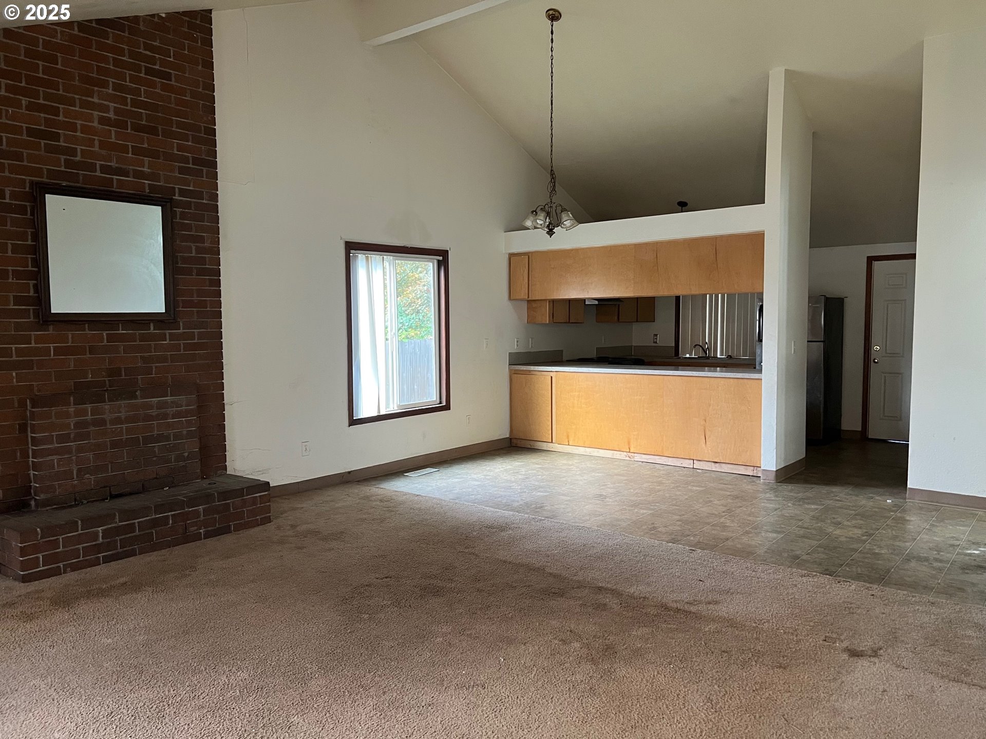 18830 Southwest Butternut Street Beaverton, OR 97078 - Photo 3 of 13 a view of empty room with a fireplace