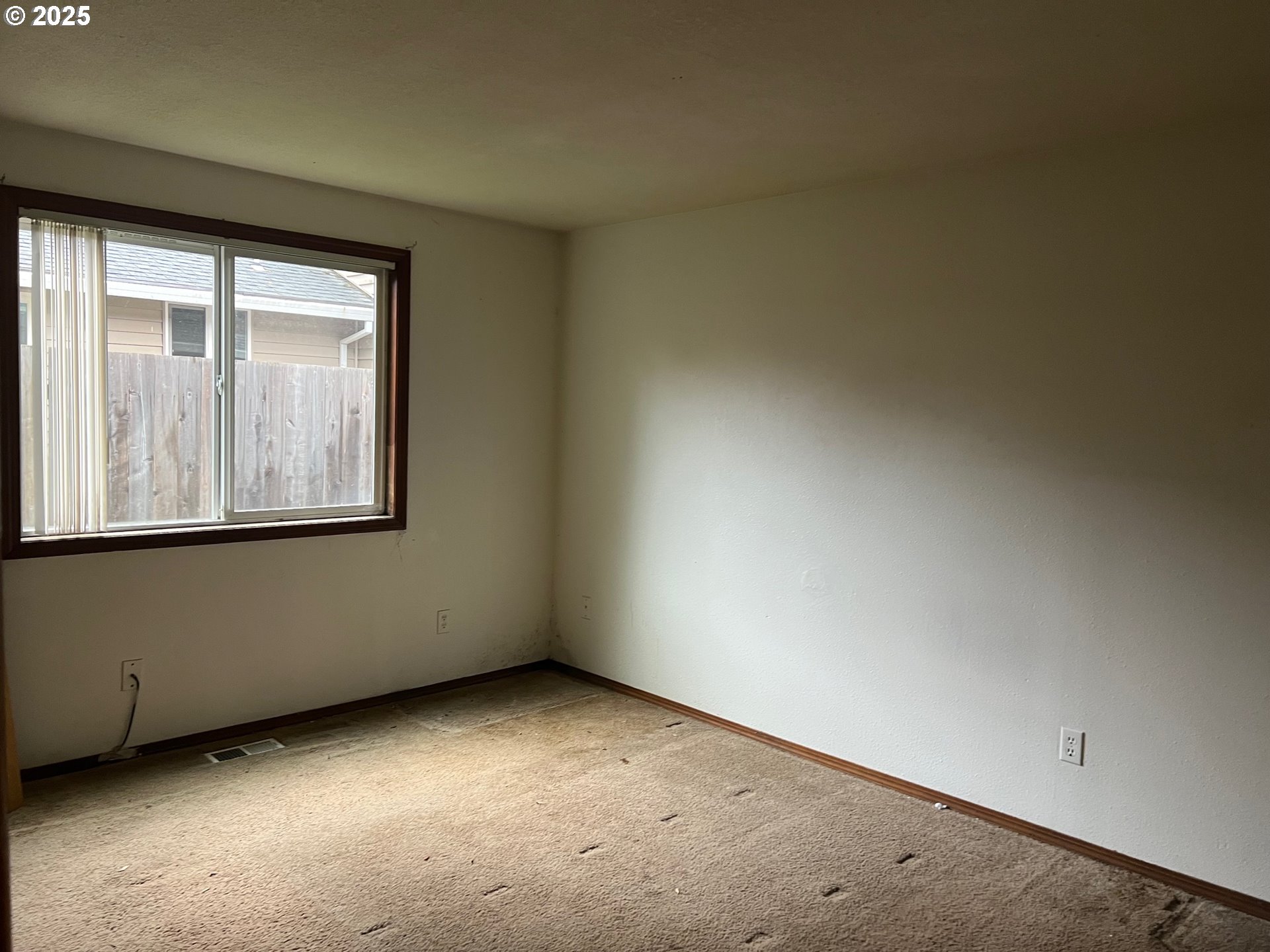18830 Southwest Butternut Street Beaverton, OR 97078 - Photo 7 of 13 an empty room with a window