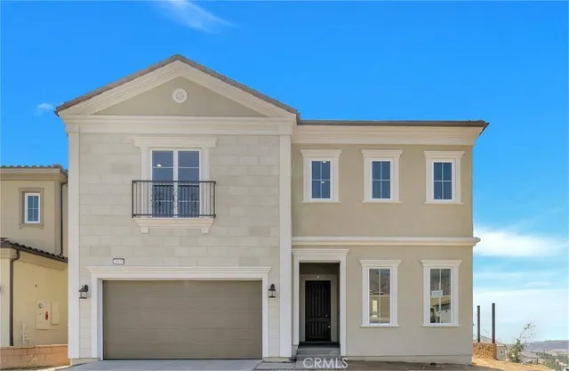 a front view of a house with many windows