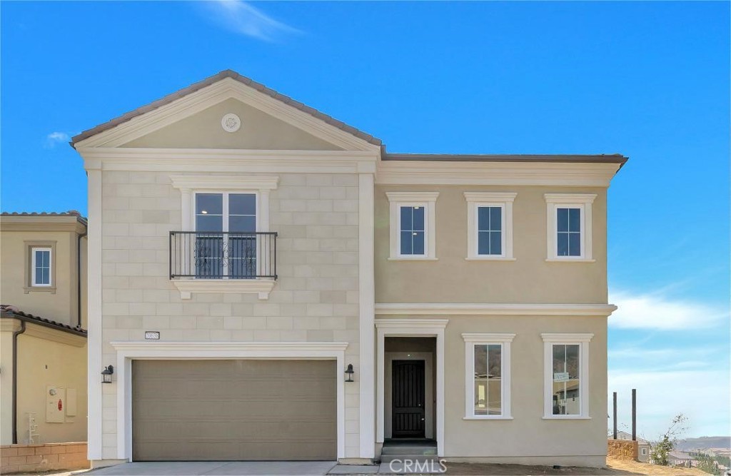 a front view of a house with many windows