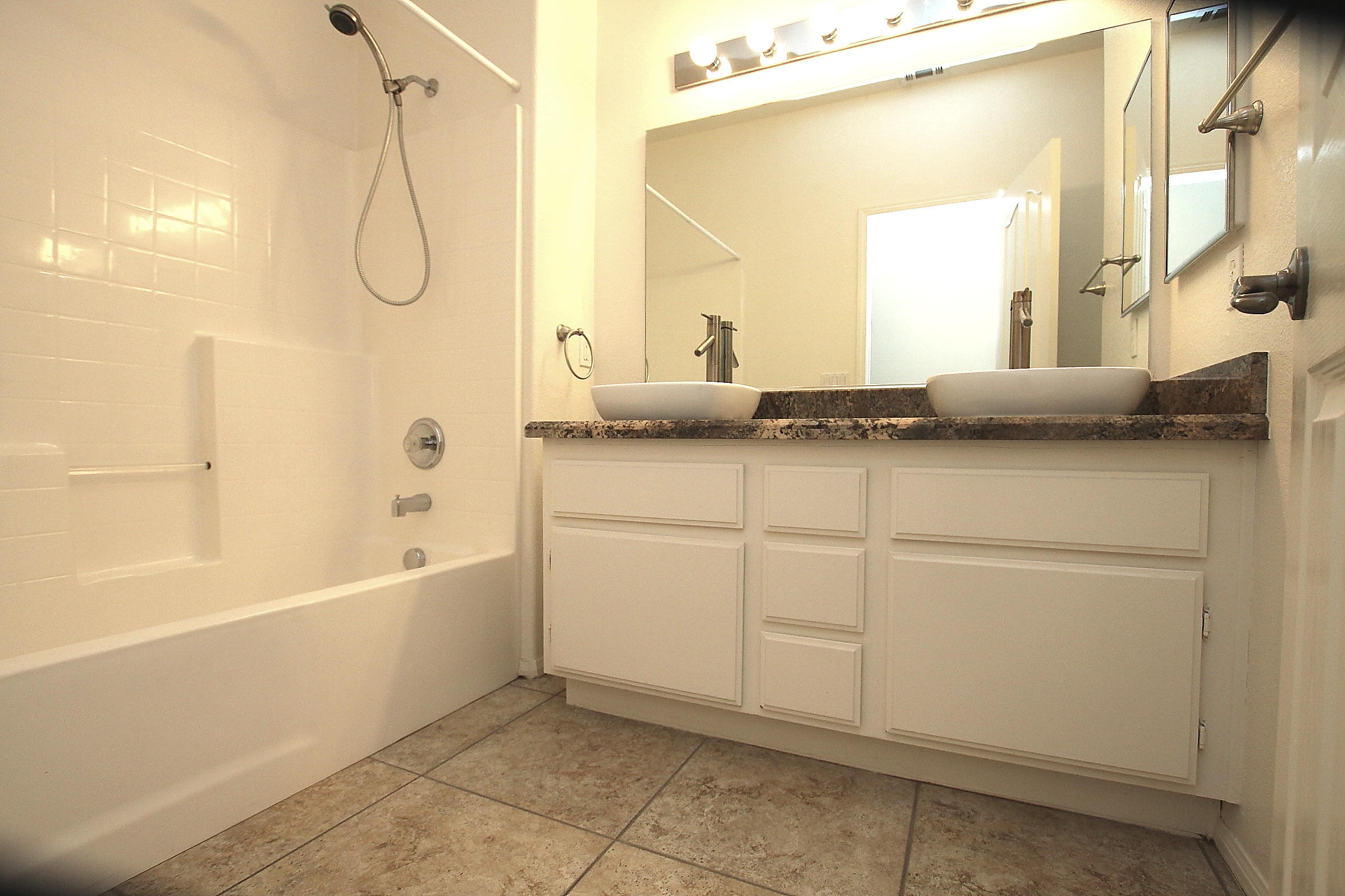 2104 Avenue J7 W Lancaster Ca West Lancaster, CA 93536 - Photo 14 of 18 a bathroom with a granite countertop sink a toilet and bathtub