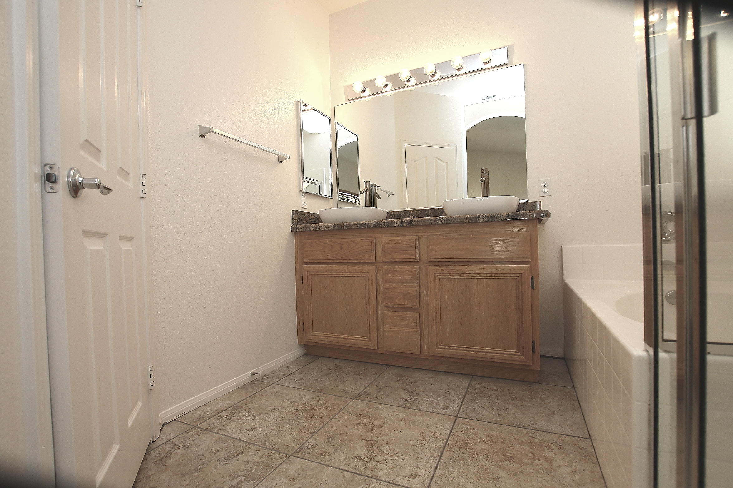 2104 Avenue J7 W Lancaster Ca West Lancaster, CA 93536 - Photo 9 of 18 a bathroom with a granite countertop sink a mirror and a vanity