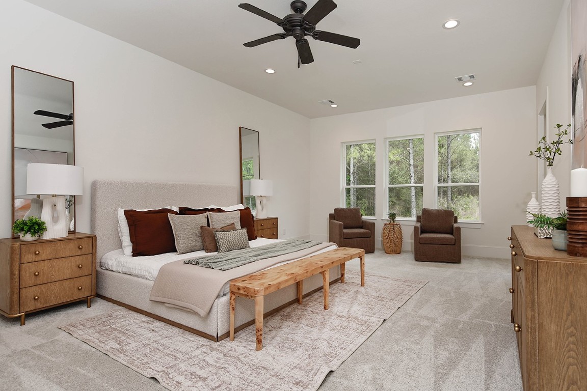 11709 Grand N Road Willis, TX 77378 - Photo 20 of 37 Inviting and peaceful primary suite. Spacious design with room for swivel lounge chairs by gorgeous windows with beautiful views.