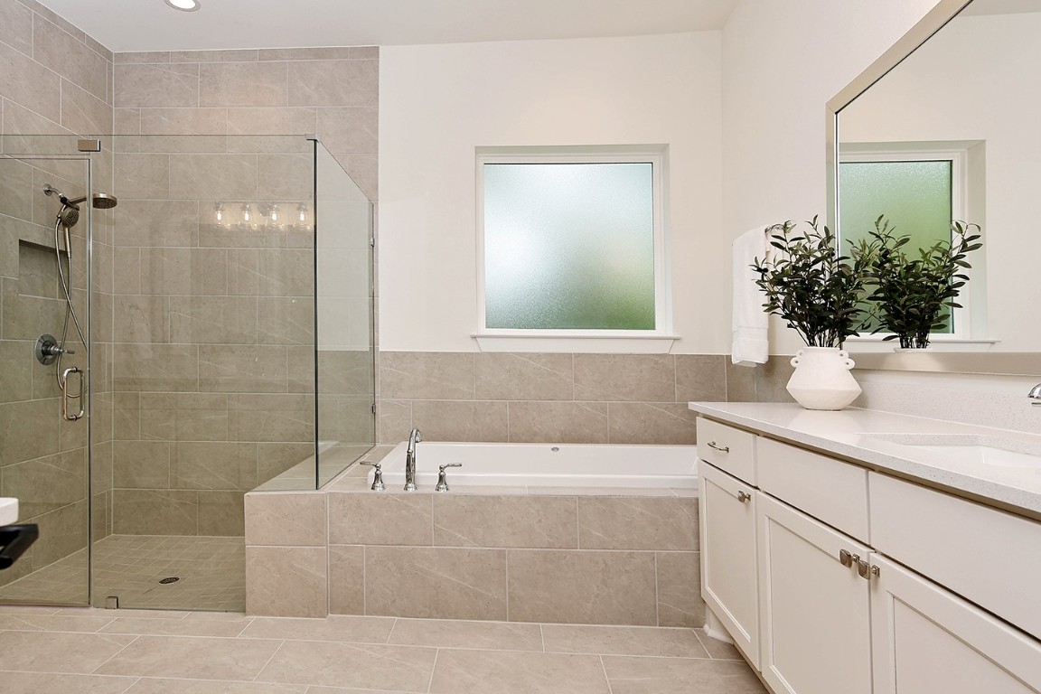 11709 Grand N Road Willis, TX 77378 - Photo 23 of 37 Spa-like spacious garden soaking tub and modern walk-in shower with frameless glass enclosure create a relaxing atmosphere.