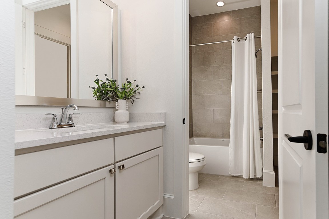 11709 Grand N Road Willis, TX 77378 - Photo 25 of 37 Bathroom 2 is pristine with quartz vanity, silver fixtures and mirror.