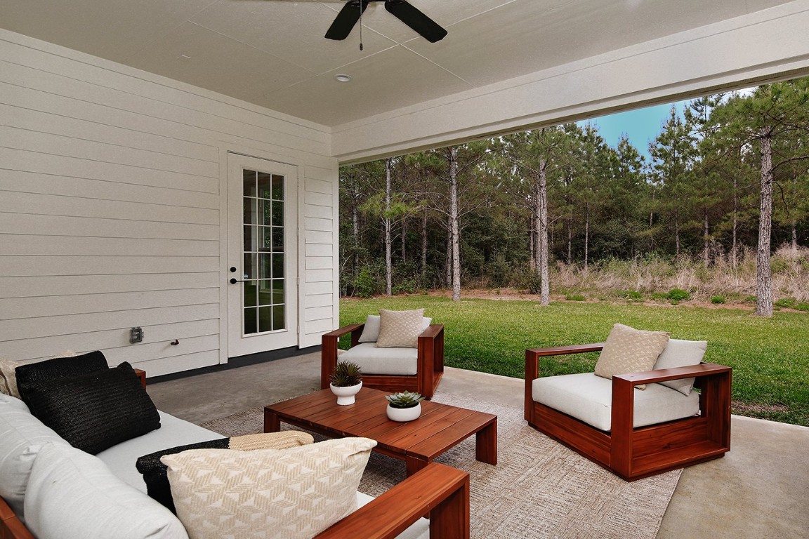 11709 Grand N Road Willis, TX 77378 - Photo 29 of 37 Gorgeous views of yard and surrounding trees from fabulous lanai with an access door from dining area and primary suite.