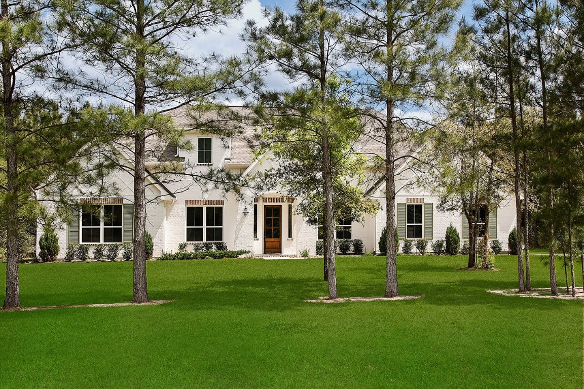 11709 Grand N Road Willis, TX 77378 - Photo 32 of 37 Spacious sprawling front lawn with elongated one-story elevation looks palatial.