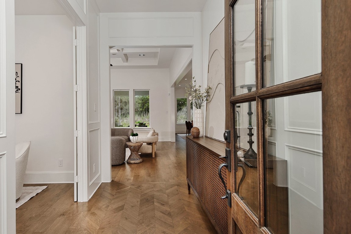 11709 Grand N Road Willis, TX 77378 - Photo 4 of 37 Entryway is inviting with tasteful designer neutral color palette, fabulous french oak wood flooring, and sightline to back windows overlooking backyard.