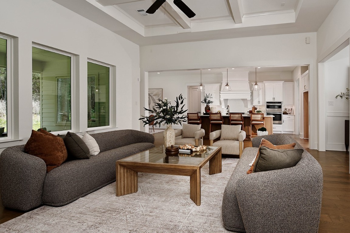 11709 Grand N Road Willis, TX 77378 - Photo 9 of 37 Spacious, open-concept living area with large windows overlooking lanai/backyard. The room flows seamlessly into kitchen with a large island with seating creating an ideal home for entertaining.