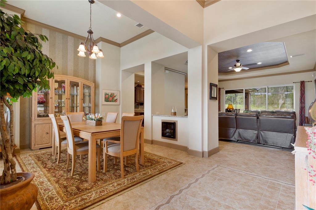 6656 Southwest 179th Ave Road Dunnellon, FL 34432 - Photo 13 of 43 a dining room with furniture a chandelier and wooden floor